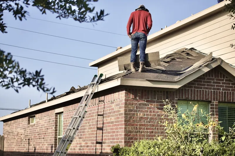 Professional roofer working on a residential roof in North Davis